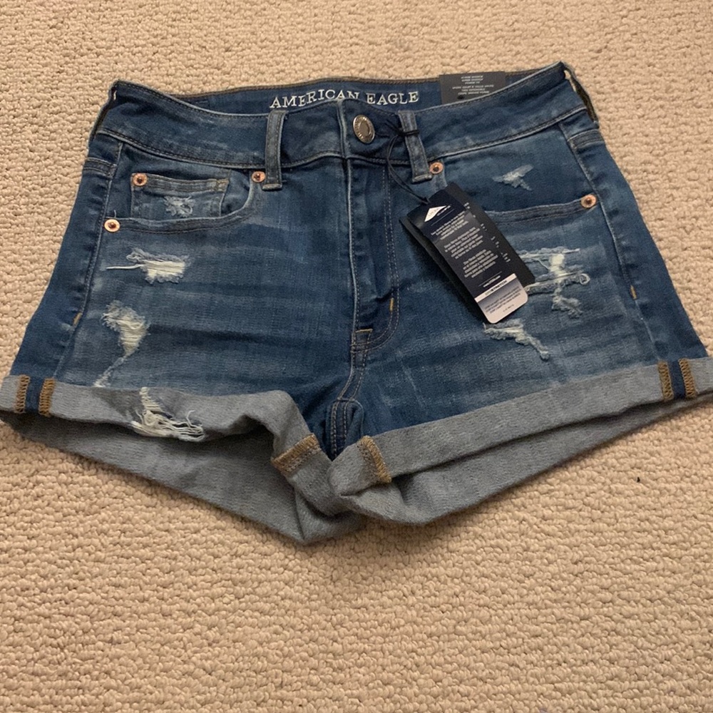 NWT American Eagle high rise jean shorts with ripped detailing on front. Size 4.